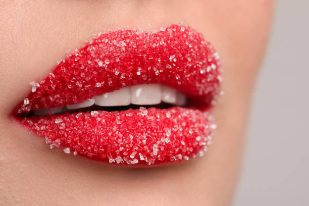 istock Young woman with beautiful lips covered in sugar, on light background, closeup 1452872124