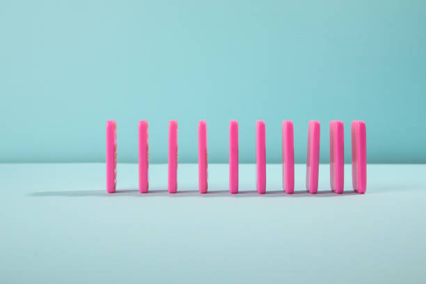 istock Pink domino on cyan background 1452872141