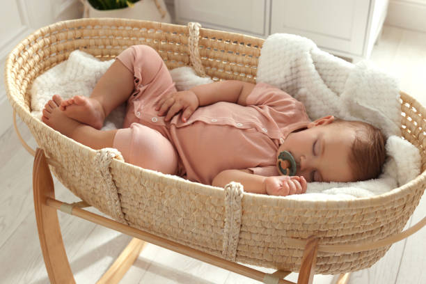 istock Cute little baby with pacifier sleeping in wicker crib at home 1452873012