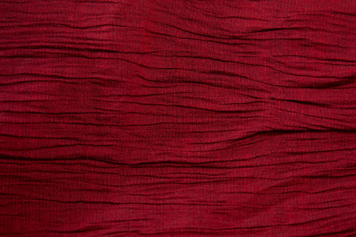 Red fabric background texture pattern. Red fabric cloth textile material.