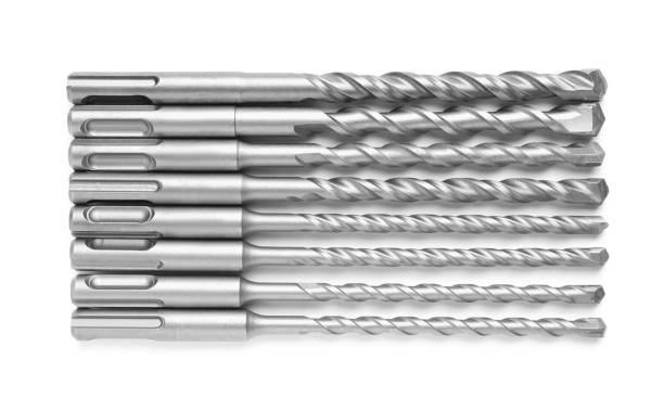 istock Many twist drill bits isolated on white, top view. Carpenter's tools 1452873800