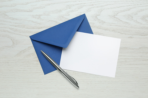 Blue  envelope and empty note. Isolated on white background. Clipping path is included.  Great use for invitation concepts.