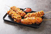 Korean style french fries corn dog Gamja hotdog closeup on the plate. Horizontal