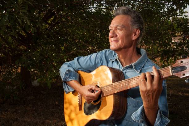 istock Man Playing Guitar in the Park 1452875116