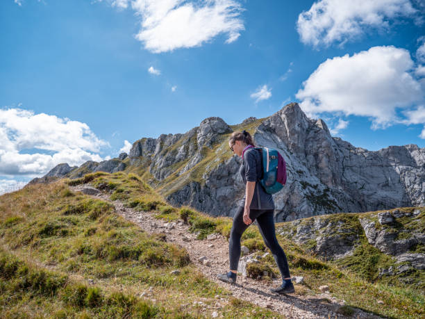 istock A woman walking among the mountains. 1452878362