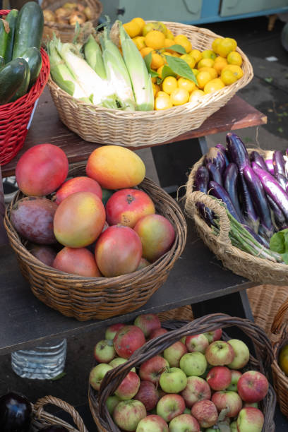 istock Baskets with apples, basket with mangoes, basket with eggplants and lettuce. Baskets of different fruits and vegetables. Street market. Fruit and vegetable stall. Open air market. Tenerife, Canary Islands, Spain. 1452878620