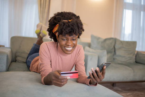 istock Cheerful  woman doing online shopping 1452881833