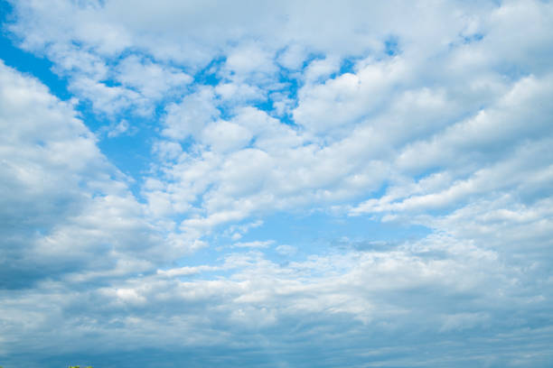 background of cloudy blue sky with white fluffy clouds.