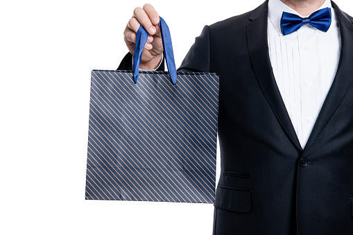 closeup purchase of shopper man on shopping sale. tuxedo shopper man with shopping bag after sale isolated on white background. shopper man after shopping sale. studio shot of man was at shopping sale