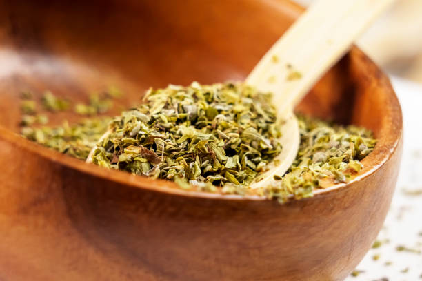 istock Crushed oregano spice on a wooden bamboo spoon 1452885357