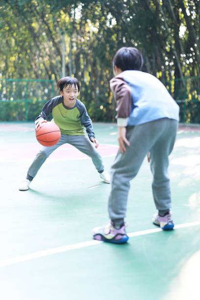 istock Two boys playing basketball outside 1452887245