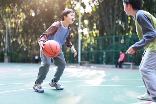 istock Two boys playing basketball outside 1452887263