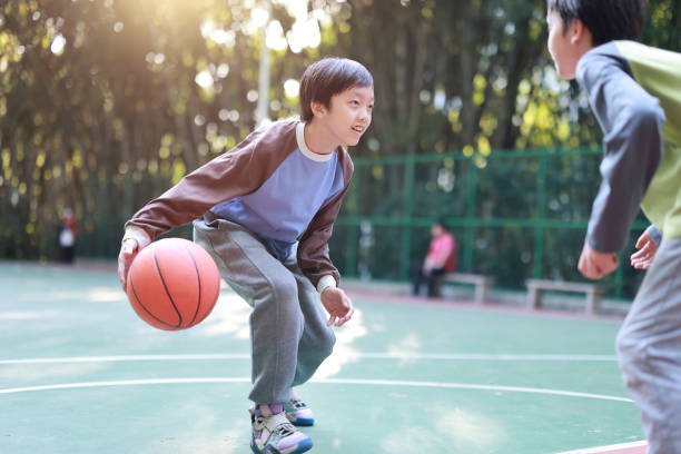 istock Two boys playing basketball outside 1452887265