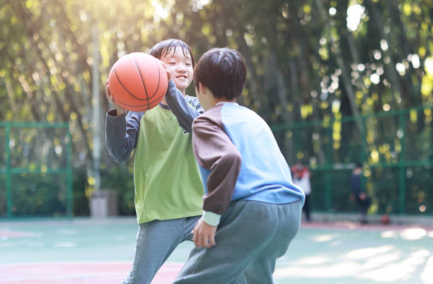 istock Two boys playing basketball outside 1452887277