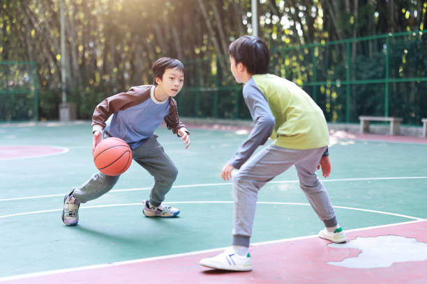 istock Two boys playing basketball outside 1452887348