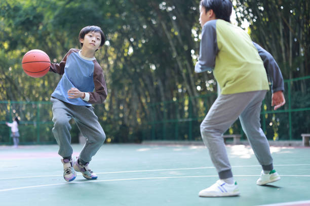 istock Two boys playing basketball outside 1452887379