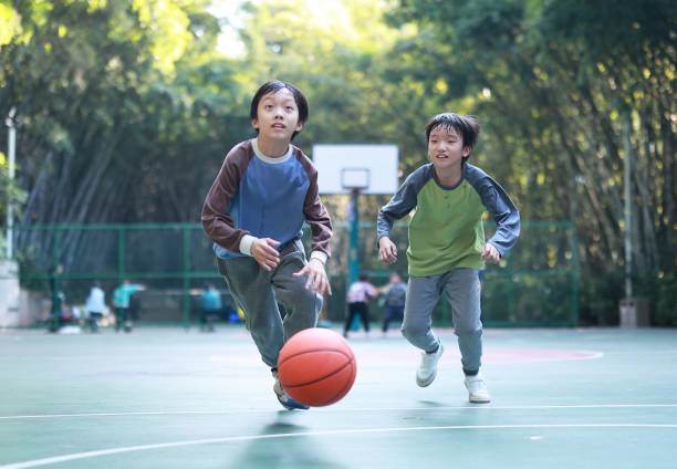 istock Two boys playing basketball outside 1452887393