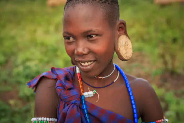 Young woman from Mursi tribe. Mursi tribe are probably the last groups in Africa amongst whom it is still the norm for women to wear large pottery or wooden discs or ‘plates’ in their lower lips.