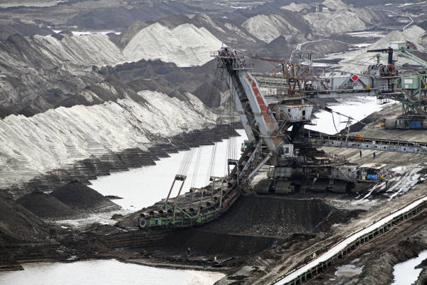istock An huge excavator on a coal surface mine. Interesting geological forms of tailings dump in an open pit coal mine. 1452888805