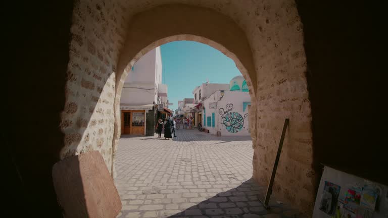 Street market of souvenirs passing through a tunnel.