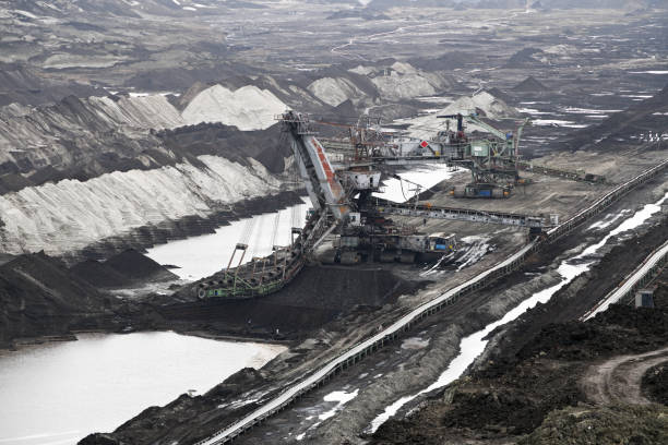 istock An huge excavator on a coal surface mine. Interesting geological forms of tailings dump in an open pit coal mine. 1452888853
