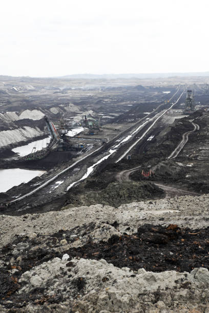 istock An huge excavator on a coal surface mine. Interesting geological forms of tailings dump in an open pit coal mine. 1452888892