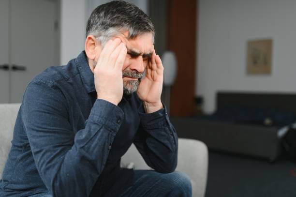istock Elderly men with headache indoor 1452892394