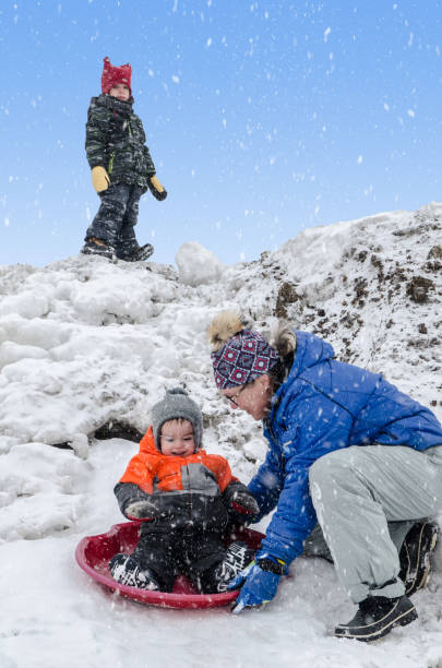 istock Young grandmother playing in snow with grandson 1452892521