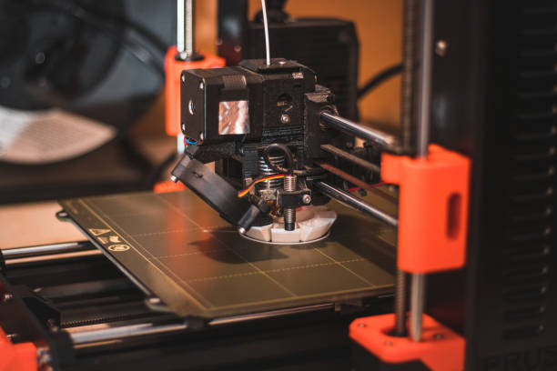 istock Technological hi-teg tool for making new things. A black and red 3D printer at work. The object is created by laying down continuous layers of material in additive processes 1452893411