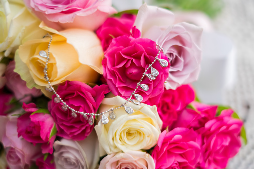 Close up of a beautiful wedding bouquet with yellow, white, pink, crimson roses. High quality photo.