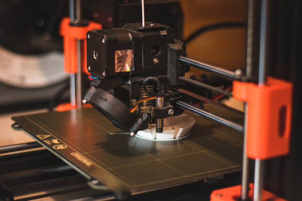 istock Technological hi-teg tool for making new things. A black and red 3D printer at work. The object is created by laying down continuous layers of material in additive processes 1452893467