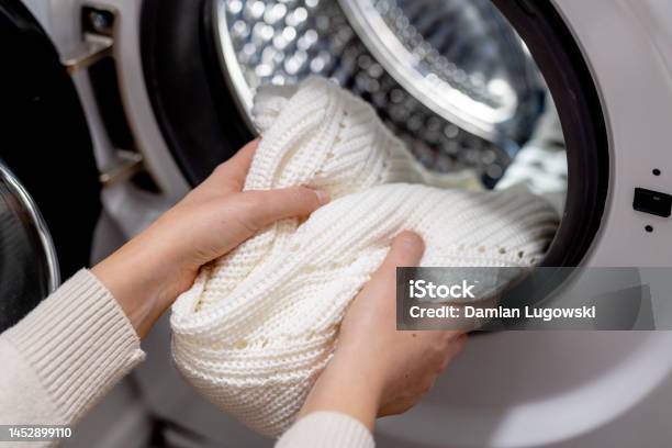 Woman Putting White Clothes Into The Drum Of A Washing Machine Front View Washing Dirty Clothes In The Washer Stock Photo - Download Image Now