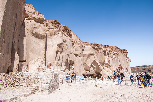 Ruta Del Sillar, Arequipa, Peru - April 15, 2022; Tourists looking at the white lavastone in one of the many quarries along the Ruta Del Sillar. With an extension of 2 km in length, visitors can experience a number of sculptures, shields, utensils and many other pieces of sillar. The material from Ruta Del Sillar is being used in Arequipa which is a city known for its buildings made out of the white lavastone.