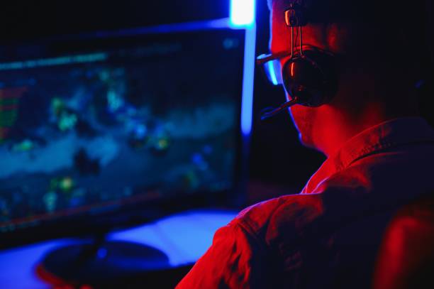 istock Gamer playing a first person shooter on high end pc. 1452901513