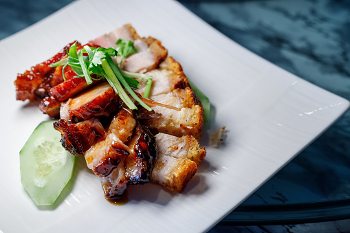 Chinese food, crispy roasted pork belly serve on a white plate