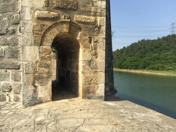 Aqueduct door with lake and forest background