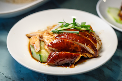 Delicious Golden Roasted BBQ Suckling pig on table. Cantonese Style.