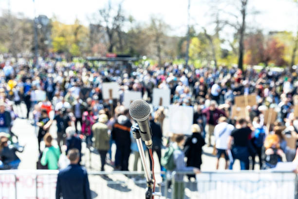 istock Unemployment strike, protest or anti government public demonstration, blurred protesting crowd in the background 1452906255
