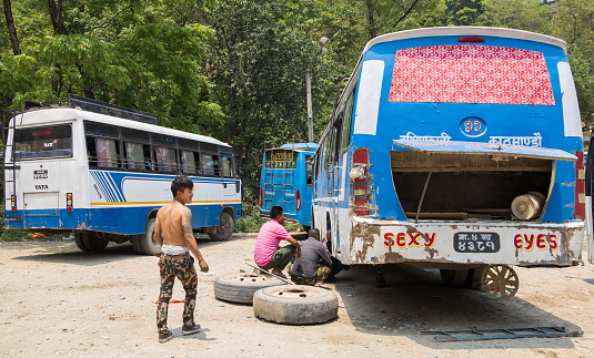 Dakshinkali Temple, Kathmandu, Nepal - April 27, 2022 : Problems for ‘Sexy Eyes’ bus. Most buses in Nepal are really old and poorly maintained due to the difficulty in obtaining parts for such old vehicles.