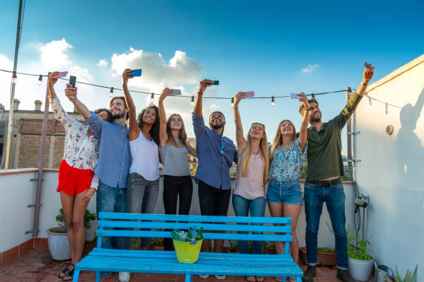 istock Front view of friends standing together on terrace 1452907136