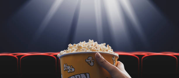 istock Woman eating popcorn at the cinema 1452908004