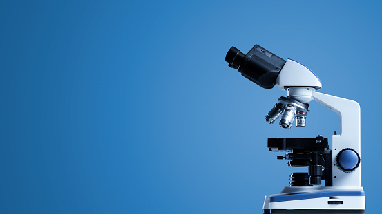 Professional laboratory microscope on blue background, science and medical research concept