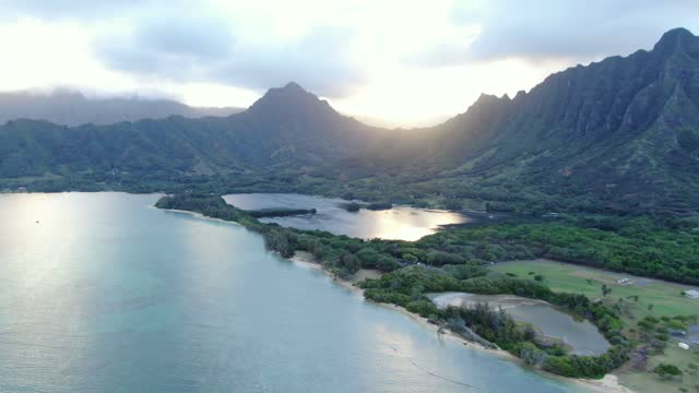 Establishing shot of Kane'ohe Bay and the Moli'i Fish Pond. Aerial reverse pull out revealing the grandeur location.
