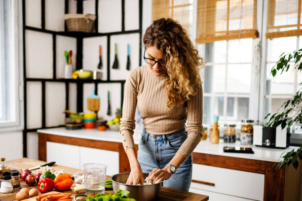 istock Young woman makes dough for pizza 1452910873
