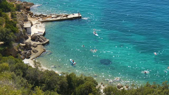 Croatia beach view from above people on paddle surf turquoise blue green water