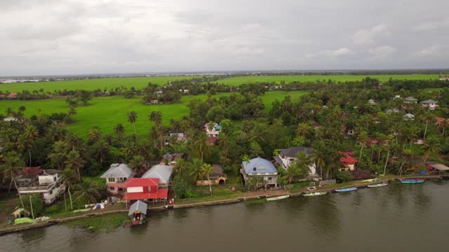 Aerial high rise revealing traditional houses in marshes of Kerala, south India.