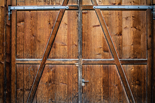 Old barn wooden door isolate on empty background. Rustic textured door