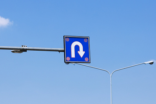 U-Turn arrow over street in sky