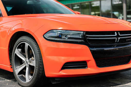 Joliet, IL, USA - April 28, 2019: The front end of a 2016 Dodge Charger. This car was built was horsepower ranging from 292 to 707 with up to a 6.4 L V8.