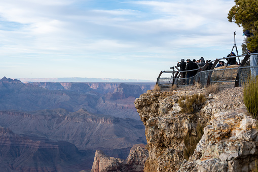 Grand Canyon, United States: March 6, 2021: Crowd Of Photographers Gathers For Sunset At Lipan Point along the Grand Canyon to illustrate the popularity of national parks